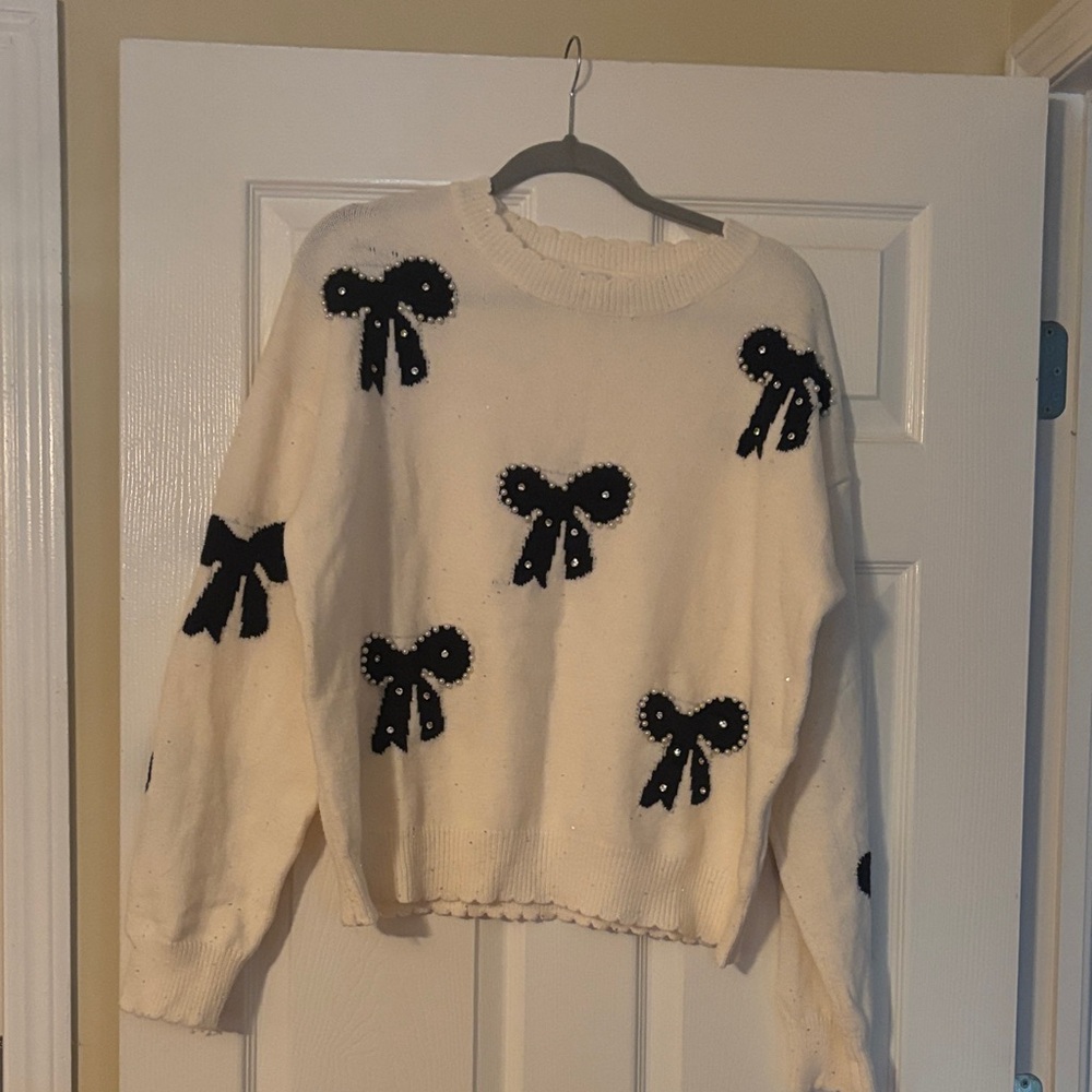 Elegant Cream Sweater with Black Bow Details